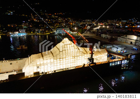 Aerial view of a luxury yacht refit, repair, service and maintenance in a floating dock at night Aerial view of a luxury yacht refit, repair, service and maintenance in a floating dock at night 140183811