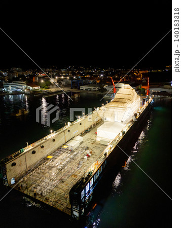 Aerial view of a luxury yacht refit, repair, service and maintenance in a floating dock at night Aerial view of a luxury yacht refit, repair, service and maintenance in a floating dock at night 140183818