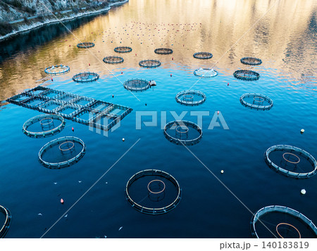 Aerial view of a fish farm located in a calm coastal bay, Aerial view of a fish farm located in a calm coastal bay, 140183819