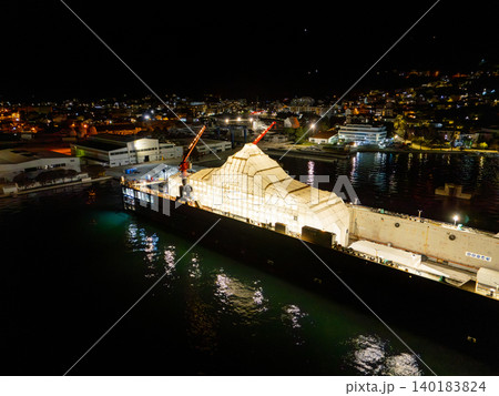 Aerial view of a luxury yacht refit, repair, service and maintenance in a floating dock at night Aerial view of a luxury yacht refit, repair, service and maintenance in a floating dock at night 140183824