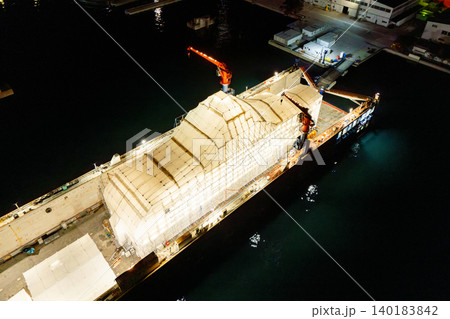 Aerial view of a luxury yacht refit, repair, service and maintenance in a floating dock at night Aerial view of a luxury yacht refit, repair, service and maintenance in a floating dock at night 140183842