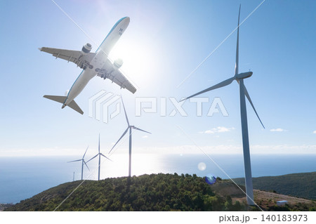 .Airplane flies above a wind farm with modern turbines. Global transition to sustainable power. 140183973