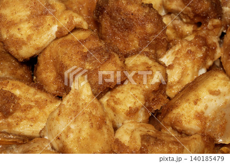 Well seasoned golden batter style chicken pieces fried and on some foil close up Well seasoned golden batter style chicken pieces fried and on some foil close up 140185479