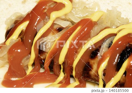 Close up of a hot dog with ketchup and mustard squirted on top dressing Close up of a hot dog with ketchup and mustard squirted on top dressing 140185500