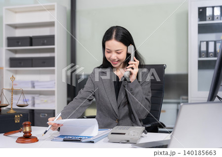 Lawyer office. gavel of Justice with scales and lawyer working on a laptop. Legal law, advice and justice concept. 140185663