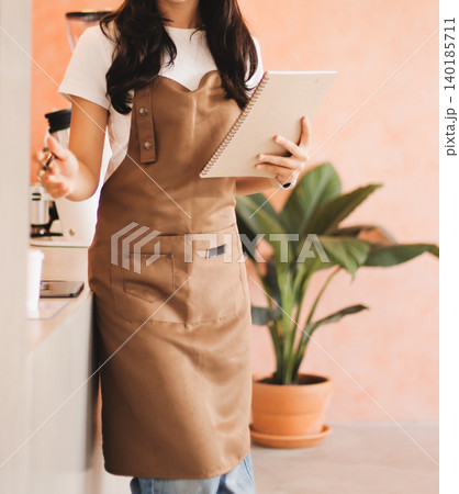 Young woman at barista school learning how to make espresso coffee. Young woman at barista school learning how to make espresso coffee. 140185711