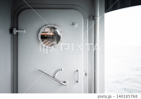 Heavy metal door with round porthole window and lever handle 140185768