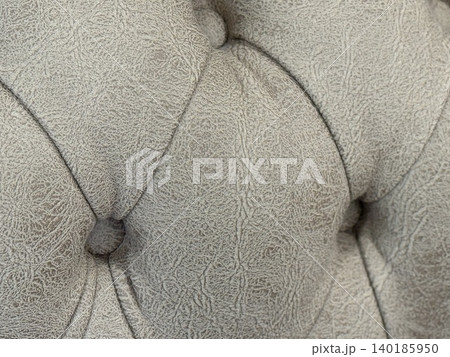 Close-up of textured gray leather upholstery with button detail, suitable for a background Close-up of textured gray leather upholstery with button detail, suitable for a background 140185950