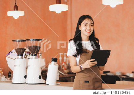 Young woman at barista school learning how to make espresso coffee. Young woman at barista school learning how to make espresso coffee. 140186452