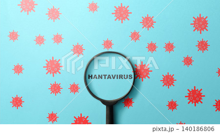 Flat lay of a magnifying glass highlighting the word Hantavirus, surrounded by red virus icons on a blue background, representing medical research and detection Flat lay of a magnifying glass highlighting the word Hantavirus, surrounded by red virus icons on a blue background, representing medical research and detection 140186806