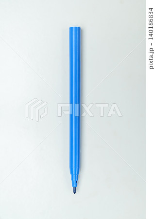 A single blue felt-tip marker pen without a cap, positioned vertically in the center of a clean, light gray background. Perfect for school, office, or art supplies concepts 140186834