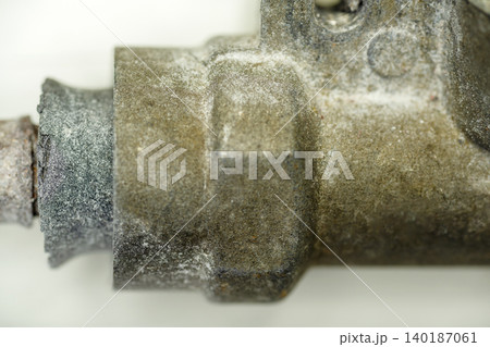 An extreme macro close-up showing heavy corrosion, rust, and oxidation on an old metal plumbing valve pipe fitting, indicating water damage and aging infrastructure An extreme macro close-up showing heavy corrosion, rust, and oxidation on an old metal plumbing valve pipe fitting, indicating water damage and aging infrastructure 140187061