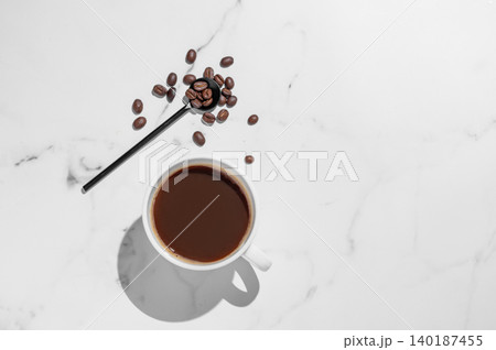 Freshly brewed espresso coffee in a cup on a white marble background Freshly brewed espresso coffee in a cup on a white marble background 140187455