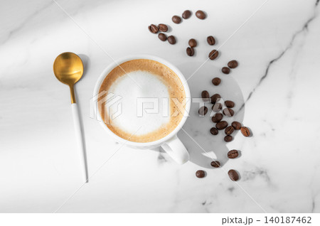 Freshly brewed cappuccino coffee in a cup on a white marble background Freshly brewed cappuccino coffee in a cup on a white marble background 140187462