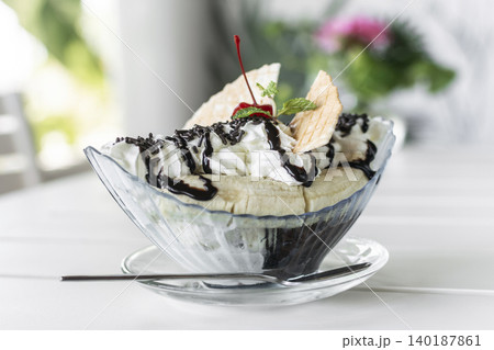 banana split ice cream sundae dessert on white table in outdoor garden cafe banana split ice cream sundae dessert on white table in outdoor garden cafe 140187861