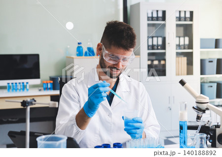 Lab technician experimenting in lab Lab technician experimenting in lab 140188892