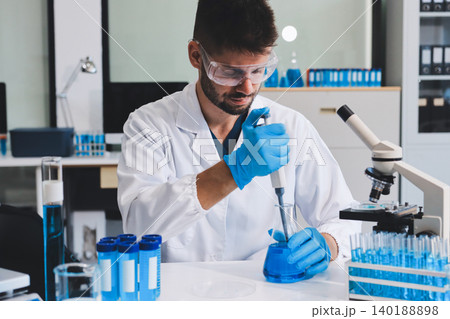 Lab technician experimenting in lab 140188898