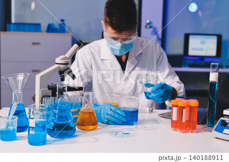 Lab technician experimenting in lab Lab technician experimenting in lab 140188911