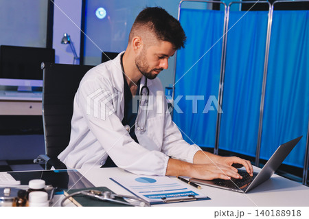 Man, doctor and laptop typing in healthcare research, communication or social media at office desk. Male medical expert working on computer in online search, browsing or chatting on tablet at clinic Man, doctor and laptop typing in healthcare research, communication or social media at office desk. Male medical expert working on computer in online search, browsing or chatting on tablet at clinic 140188918