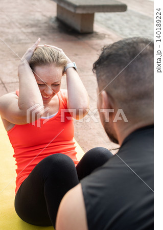 Mature Woman Doing Abs Workout on Yoga Mat Outdoors Mature Woman Doing Abs Workout on Yoga Mat Outdoors 140189224