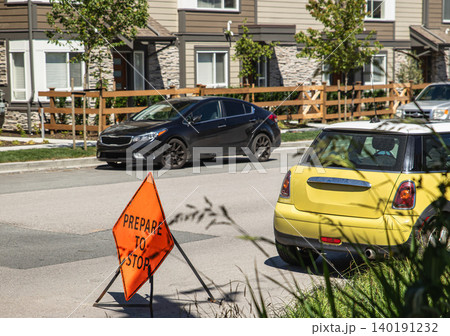 Roadworks with Orange metal Sign Prepare to Stop on the city street. A road construction sign warns oncoming traffic. Nobody, street photo. Construction, road repair works and safety signage concept Roadworks with Orange metal Sign Prepare to Stop on the city street. A road construction sign warns oncoming traffic. Nobody, street photo. Construction, road repair works and safety signage concept 140191232