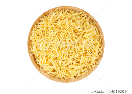 Crispy, shoestring-style potato sticks served on a round wooden plate. Traditional Brazilian shoestring fries isolated on a white background 140192054