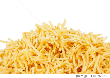 Stacked shoestring potatoes isolated on a white background. A traditional side dish in Brazilian cuisine Stacked shoestring potatoes isolated on a white background. A traditional side dish in Brazilian cuisine 140192058