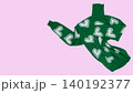 Green knitted turtleneck sweater with white hearts pattern floating in air on pink background, copy space. 140192377