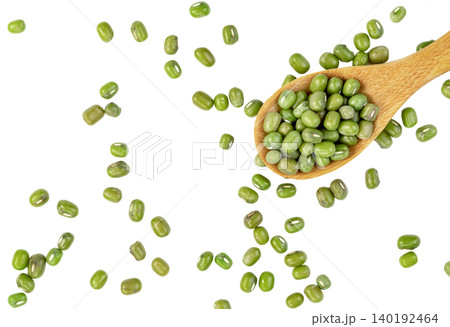 Top view of green mung beans scattered with a wooden spoon. Healthy plant-based protein source and dry legumes for cooking. Isolated. 140192464