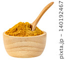 Turmeric powder in a small wooden bowl with a wooden spoon isolated. Yellow curry spice for cooking and healthy supplements. High quality studio shot for food concepts. 140192467
