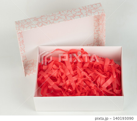 Bright red shredded paper in a gift box Bright red shredded paper in a gift box 140193090