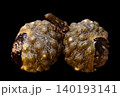 two big of Sichuan peppers green isolated very close on a black 140193141