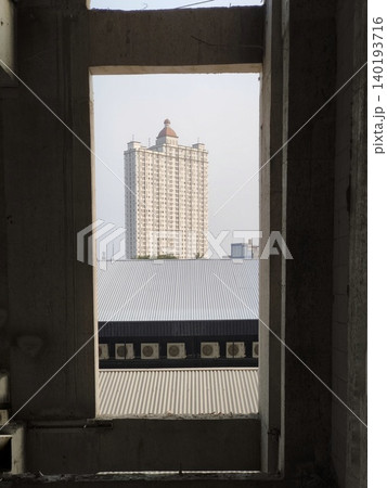 Skyscraper Seen from Concrete Window Frame Skyscraper Seen from Concrete Window Frame 140193716