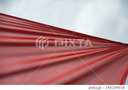 Red Color Cloth Flying In Wind 140194016