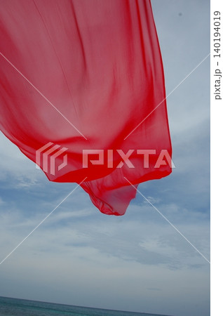 Red Color Cloth Flying In Wind 140194019