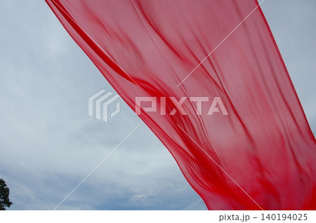 Red Color Cloth Flying In Wind 140194025