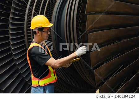 Professional engineer male working service power plant turbine fan blade electrical generator Professional engineer male working service power plant turbine fan blade electrical generator 140194124