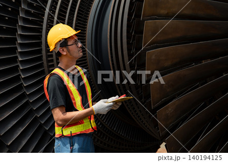 Professional engineer male working service power plant turbine fan blade electrical generator Professional engineer male working service power plant turbine fan blade electrical generator 140194125