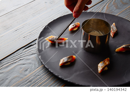 Bota sardine preparation with chef hand Bota sardine preparation with chef hand 140194342
