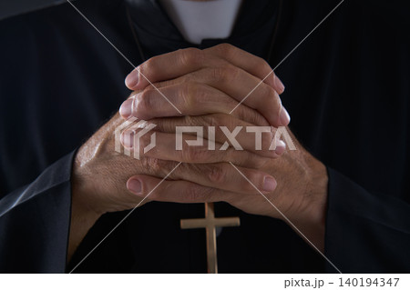 Praying hands priest portrait of male 140194347