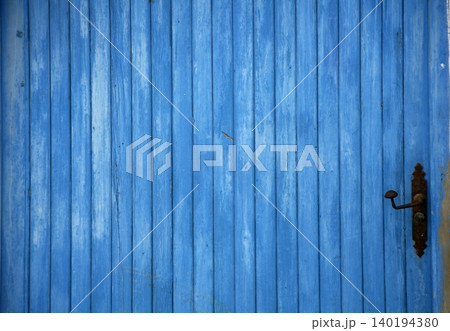 Blue old wooden door detail with handle 140194380