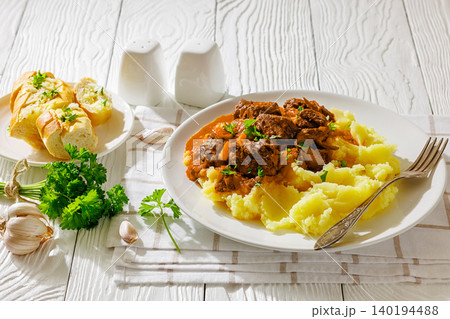 slow cooked beef meat stew served with mashed potatoes slow cooked beef meat stew served with mashed potatoes 140194488