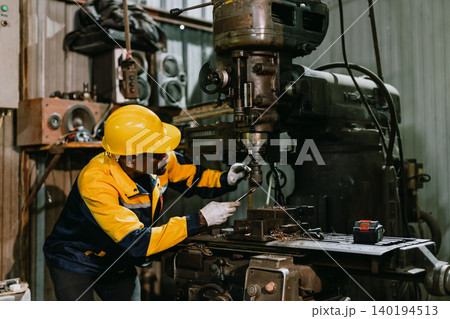 Professional African black Engineer male worker work with metal lathe machine in metal part factory Professional African black Engineer male worker work with metal lathe machine in metal part factory 140194513