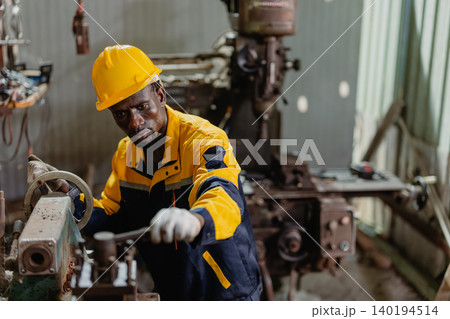 Professional African black Engineer male worker work with metal lathe machine in metal part factory Professional African black Engineer male worker work with metal lathe machine in metal part factory 140194514