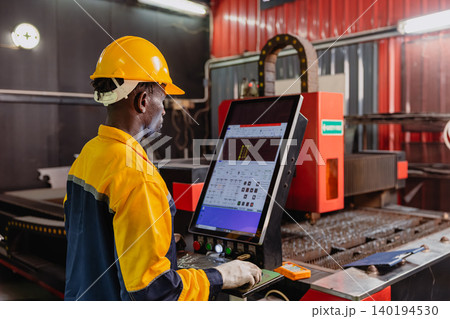 Professional African black engineer male technician expert worker control operate machine in plant 140194530