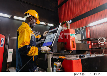 Professional African black engineer male technician expert worker control operate machine in plant Professional African black engineer male technician expert worker control operate machine in plant 140194538