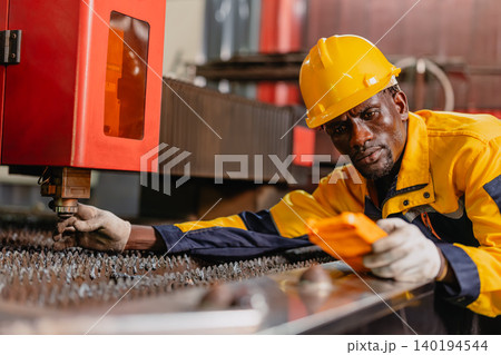 Professional African black engineer male technician expert worker control operate machine in plant 140194544
