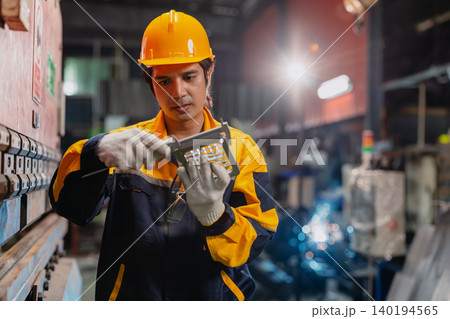 Professional Engineer male worker working check product quality measuring metal part with Vernier. Professional Engineer male worker working check product quality measuring metal part with Vernier. 140194565