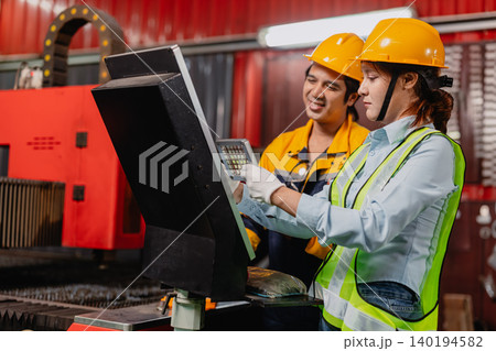 Engineer teamwork, Workers man and woman team working together in metal workshop plant factory. 140194582