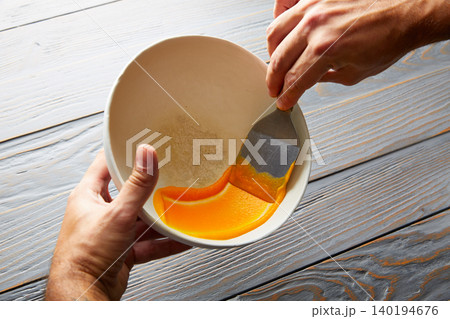 creamy carrot cream painted on white bowl 140194676